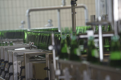 Bottling of mineral water in green bottles, in an industrial plant