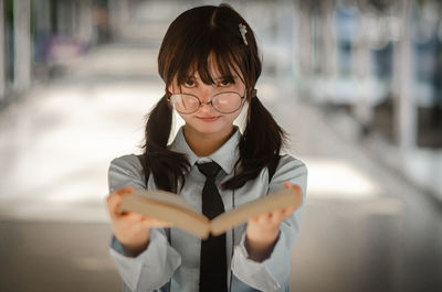 Portrait of smiling girl standing outdoors