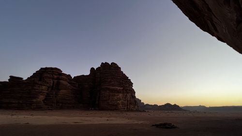 Rock formations against sky during sunset