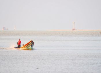 Nautical vessel on sea against clear sky