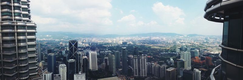 Cityscape against cloudy sky