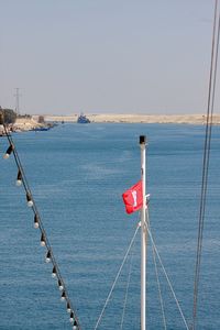 Close-up of railing by sea against clear sky