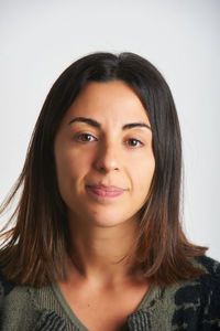 Portrait of young woman against white background