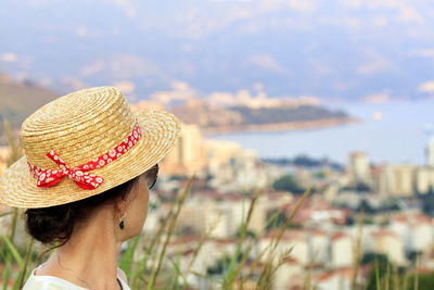Close-up of woman wearing hat looking away