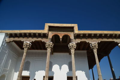 Low angle view of historic building against clear blue sky