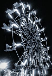 Low angle view of illuminated ferris wheel
