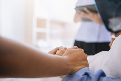 Close-up of people holding hands