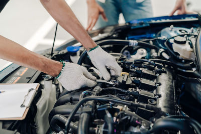 Close-up of man working on motorcycle