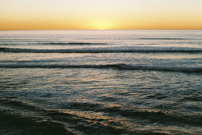 Scenic view of sea against clear sky during sunset