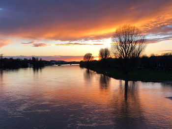 Scenic view of lake against romantic sky at sunset
