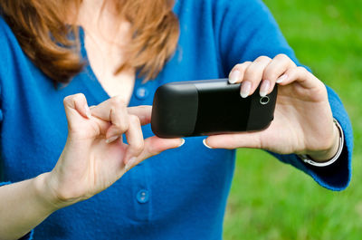 Midsection of woman using mobile phone