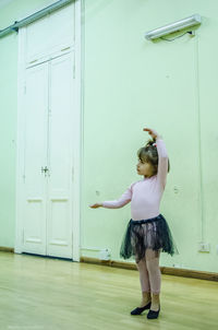 Full length of young woman jumping