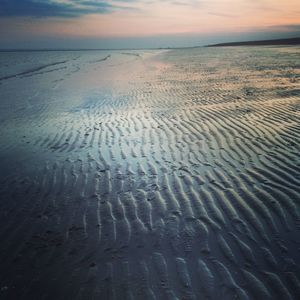 Scenic view of beach at sunset