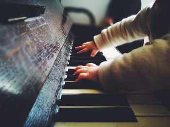 Midsection of person playing piano