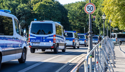 Police cars on road in city