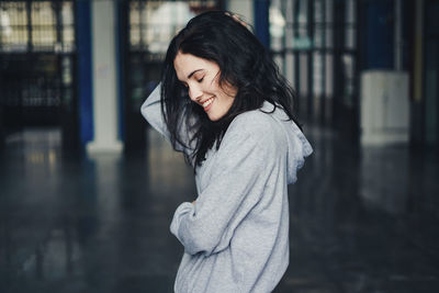 Smiling young woman with eyes closed