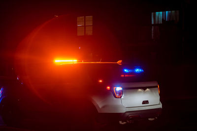 Cars on illuminated street at night