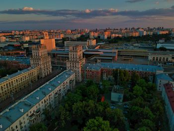 High angle view of buildings and trees against sky at sunset