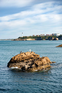 Scenic view of sea and buildings against sky