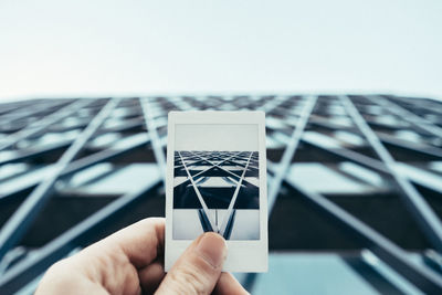 Cropped image of hand holding paper