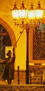 Low angle view of illuminated lamp in building