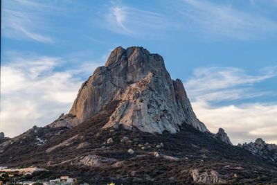 Low angle view of rock formation against sky