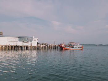 Fishing boat in sea against sky