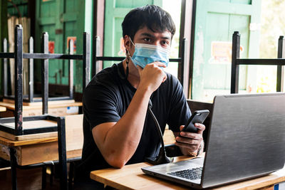 Young woman using laptop at table