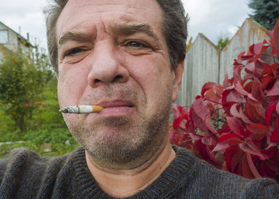 Close-up of mature man smoking cigarette