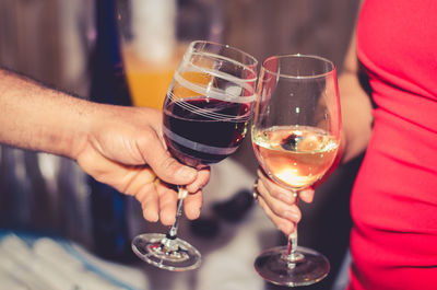 Close-up of couple toasting wineglasses