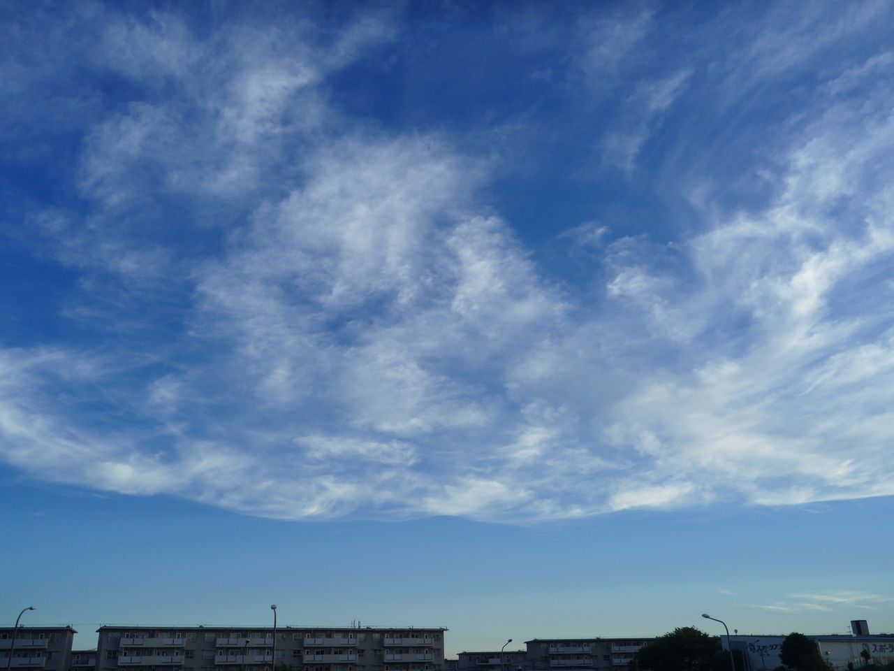 blue, low angle view, sky, city, architecture, building exterior, cloud - sky, cloud, development, day, city life, beauty in nature, scenics, nature, cloudscape, outdoors, high section, residential district, tranquility, modern, building story, no people, distant, office building, cloudy, tranquil scene, majestic