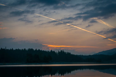 Scenic view of vapor trails against sky during sunset