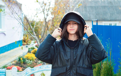 Portrait of young woman standing outdoors