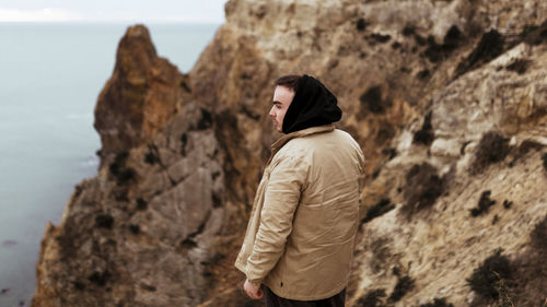 Rear view of man standing on rock