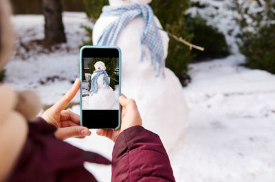 Midsection of woman using mobile phone