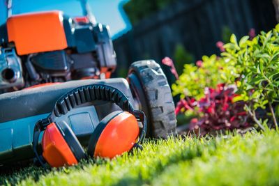 Close-up of lawn mower on field