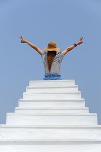 Low angle view of woman standing on staircase