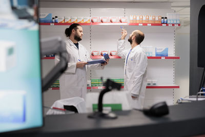 Midsection of scientist working in laboratory