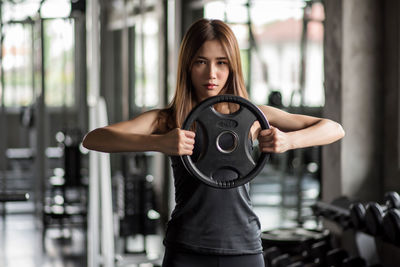 Young woman exercising in gym