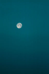 Low angle view of moon against blue sky