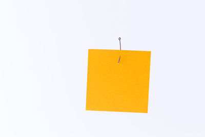 Close-up of yellow lamp against white background