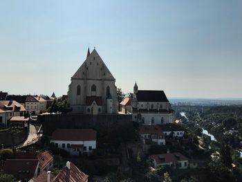 Buildings in town against clear sky