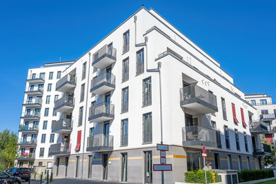 Low angle view of building against clear blue sky