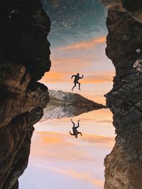 Silhouette rock formations against sky during sunset