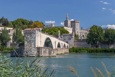 Arch bridge over river against buildings