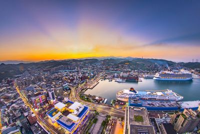 High angle view of illuminated buildings against sky during sunset