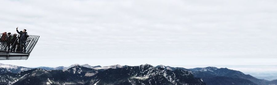 Low angle view of mountains against sky during winter