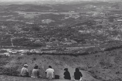People on landscape against sky
