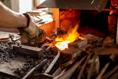 The blacksmith in production process of metal products, handmade in the forge. 