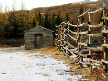 Wooden charnel-house at the cemetery in kuujjuq, quebec by the mountains